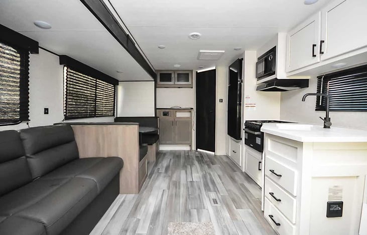 Lots of storage and cabinets. Heater/AC and hot water. Fresh, grey and black water tank meter. Fresh/city water tank. Lots of lights. Power and USB outlets.