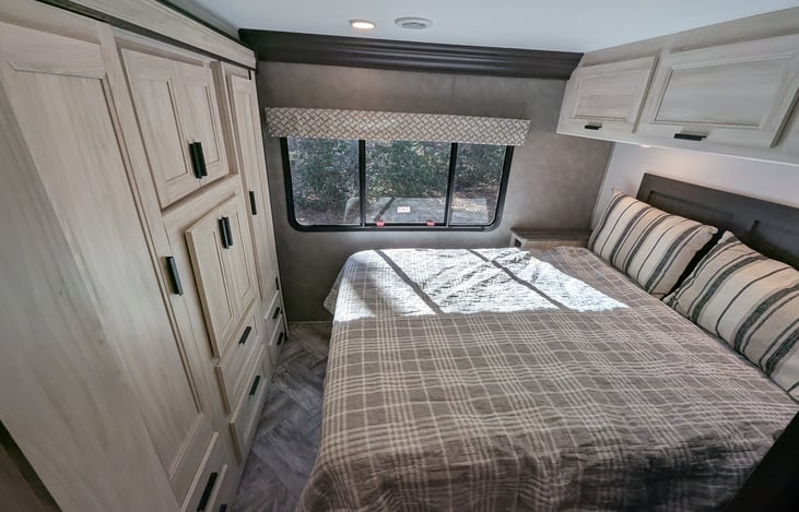 Cozy private bedroom with Queen bed and ample storage at the rear.