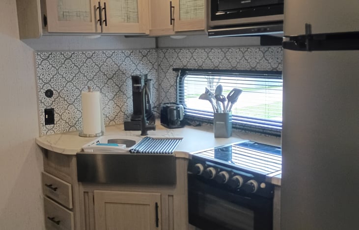Spacious kitchen with all the convenience of home.  Dishes, pot and pans, utensils, keurig coffee maker, toaster, microwave, stove and nice sized fridge.