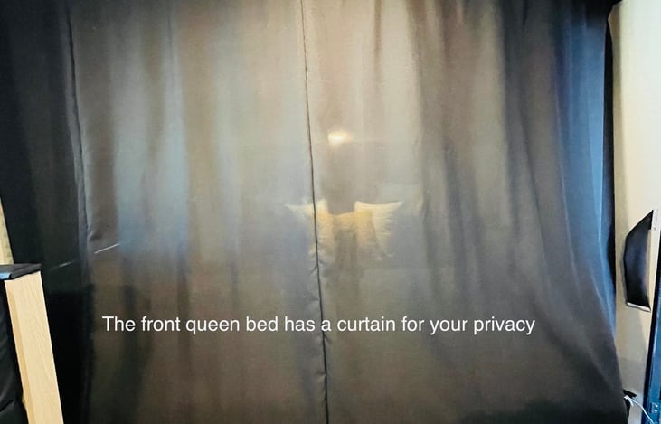 The front bedroom has privacy when you need it with a full-length curtain.