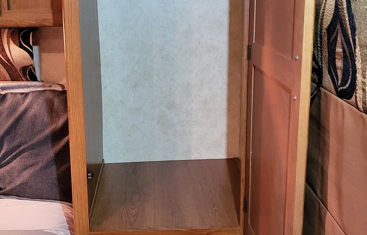 1 of 2 master bedroom closet with hanger rod and pull out drawer