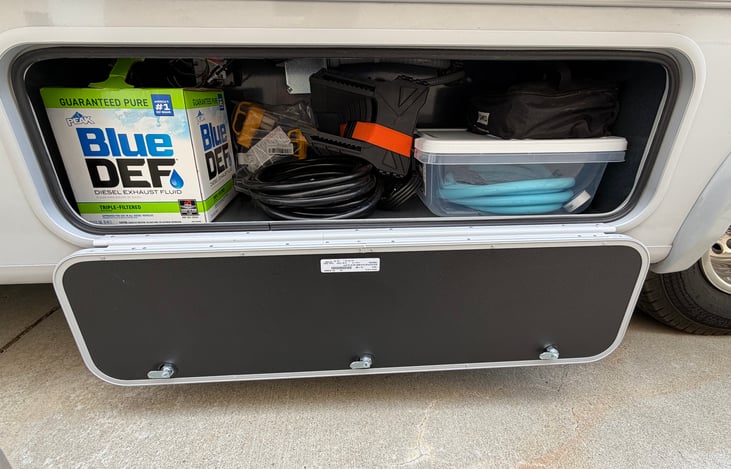 Storage includes, fresh water hose, 30 AMP Cable with Adapters, Sewer hose support, cable for TV, and Levelers. Also comes with Diesel Exhaust Fluid that needs to be put in if you are traveling 1200 o