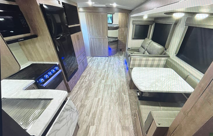 Back of RV has a set of bunk beds, R recliners and a drop-down table for an extra bed.