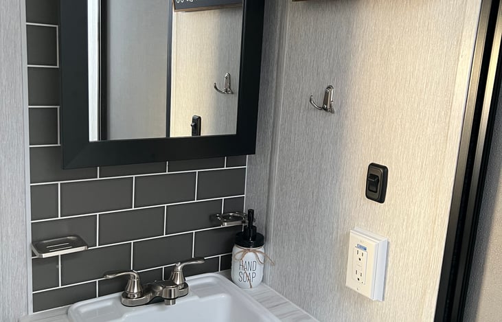 Bathroom with its own entrance!  No need to wake a sleeping baby, or walk through the entire rig just to use the bathroom. 

Hand soap and 4 rolls RV grade toilet paper included