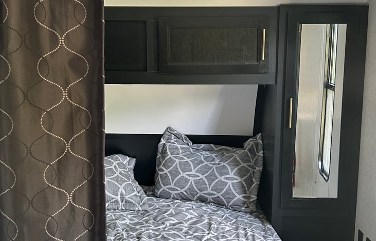 A blackout curtain divides the master from the rest of the camper