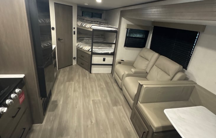 Livingroom area containing 2 recliners and the bunk beds. Each bunk bed can sleep 2 small children.