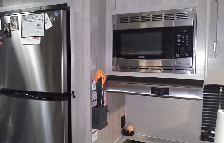 Large refrigerator freezer and microwave.