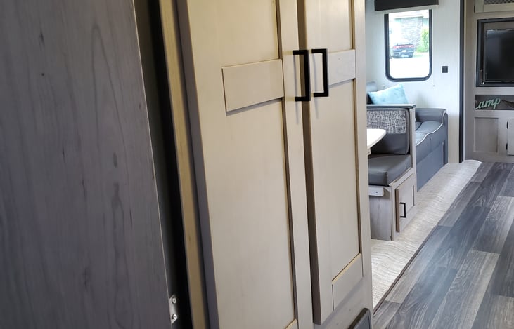 Storage area with bath towels, wash cloths also toilet paper.