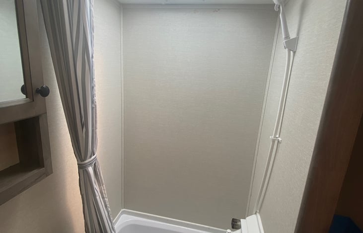 Sky-light provides extra space and great light for the shower. Small tub as well is great for bath time for the children.