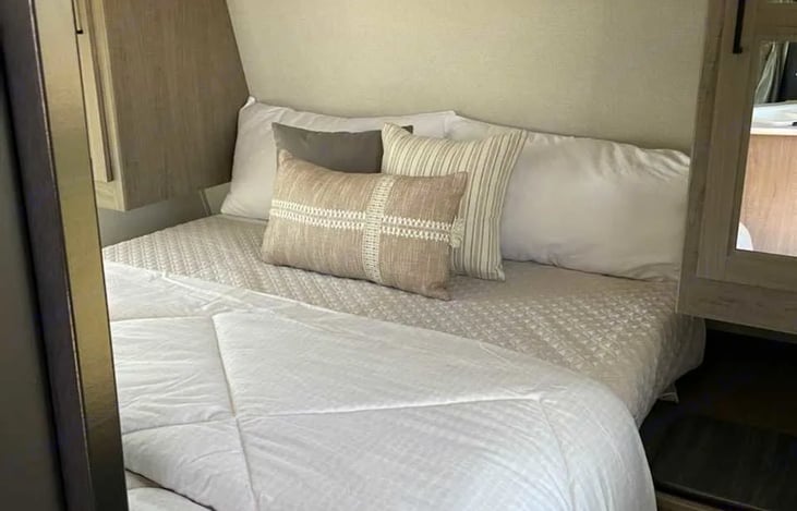 Queen in front of trailer.