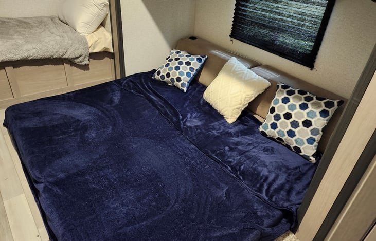 futon folded out and sleeps 2 plus overhead bunk.