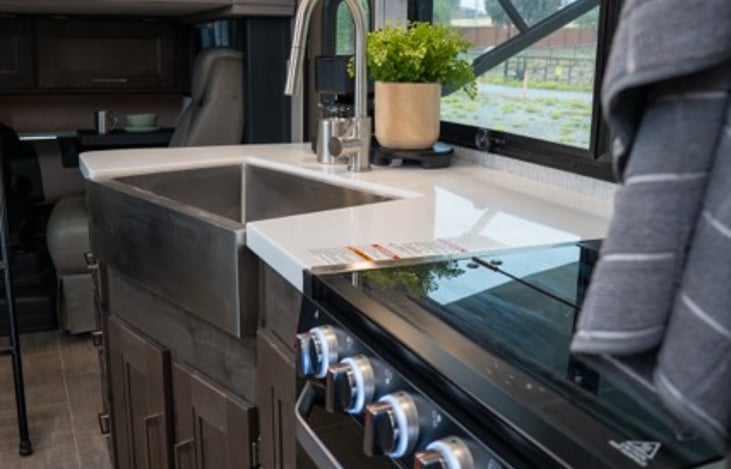 fully stocked kitchen with farmhouse sink