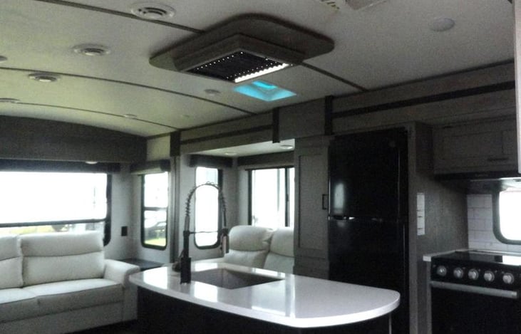 Picture is not exact the camper has brown furniture.