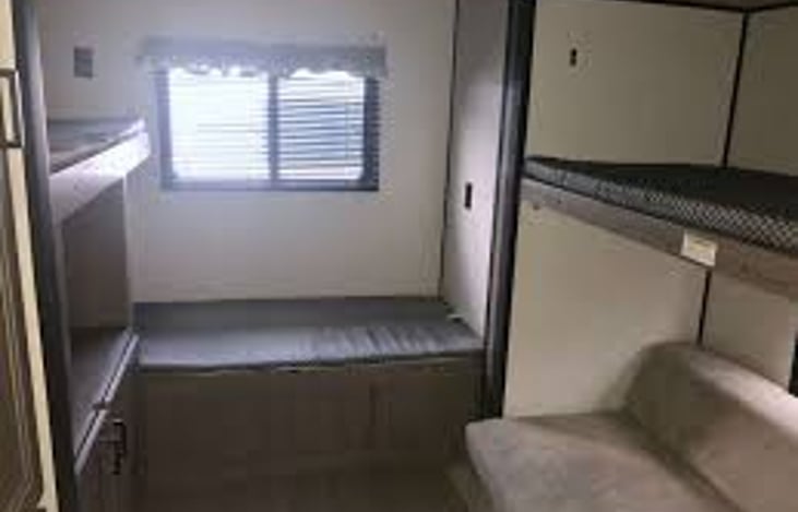 Bunk room with multiple bed options and additional storage.