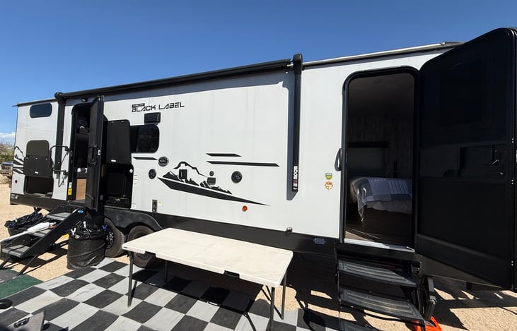 Outside set up. Extra Table provided with floor mats. Awning doe work but does not have auto retract if wind picks up so, we leave it closed when we set up.