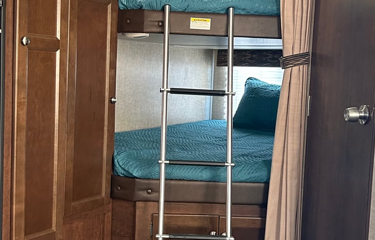2 Full size bunks. Top bunk includes a TV. Large underneath storage