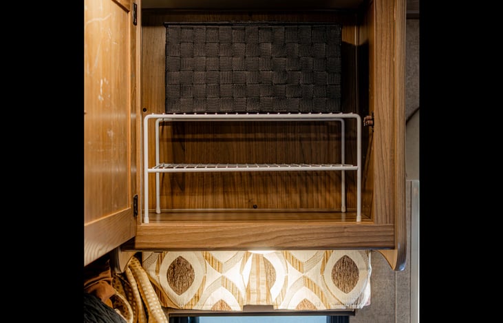 Convenient overhead cabinet with added shelf and storage basket