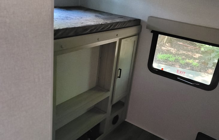 Twin bed above the entertainment center in the bunk house