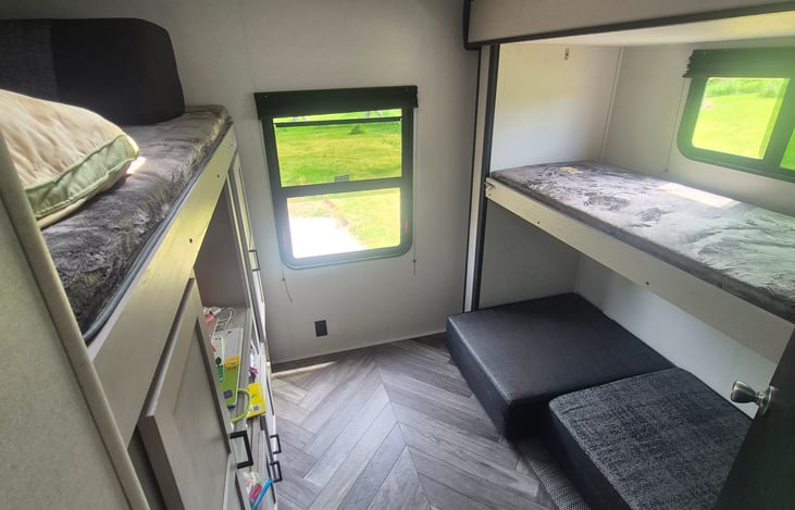 Bunk on left is full sized, the single bunk is a twin, the bottom cushions can be a couch, or fold into twin or queen size bed (depending on how you fold cushions)