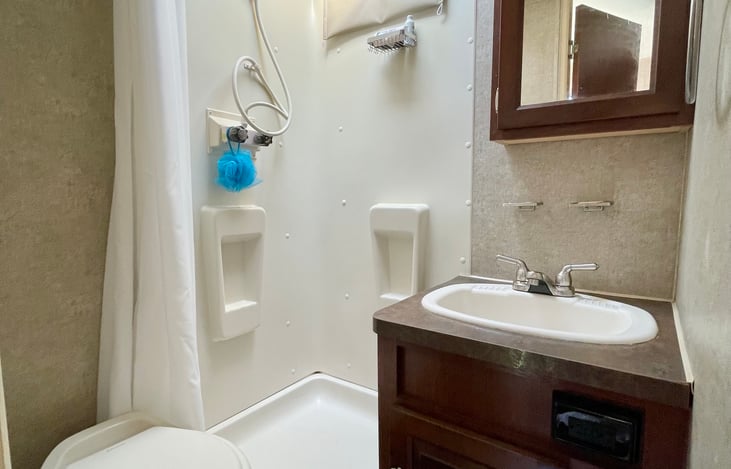 You're not roughing it anymore with this shower, toilet, and sink. ;)