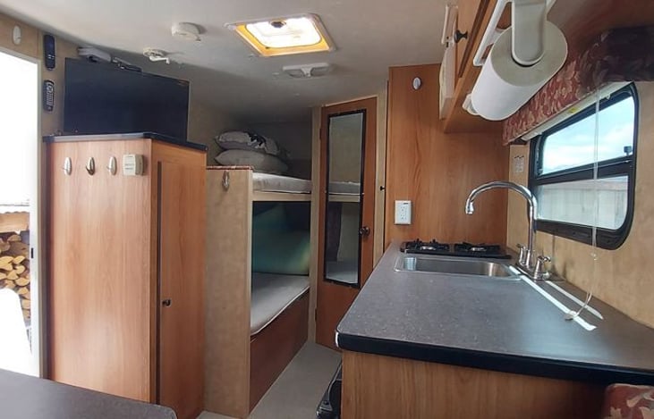 bunk beds, kitchen and storage cabinet