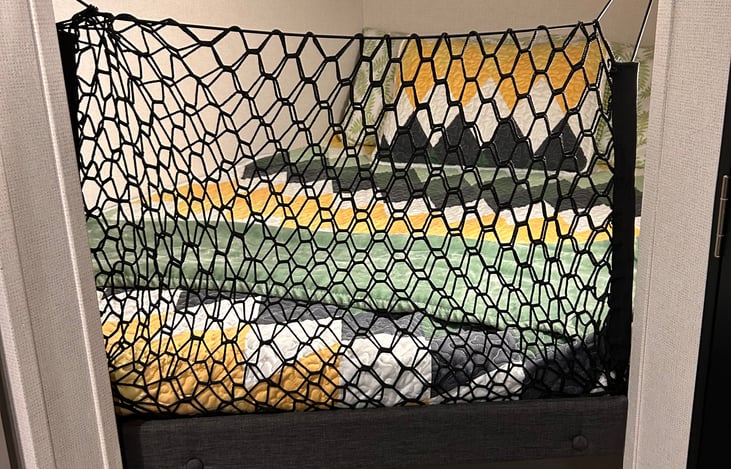 We added a cargo net to this bunk to keep our toddler from falling out when she naps here.