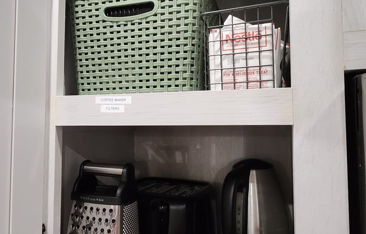 The cheese grater, toaster, electric kettle, and coffee maker are all included.