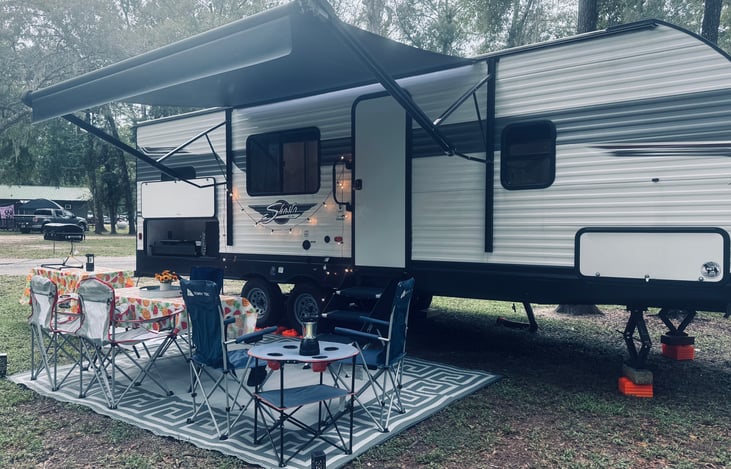 Outdoor kitchen includes small refrigerator and movable sink