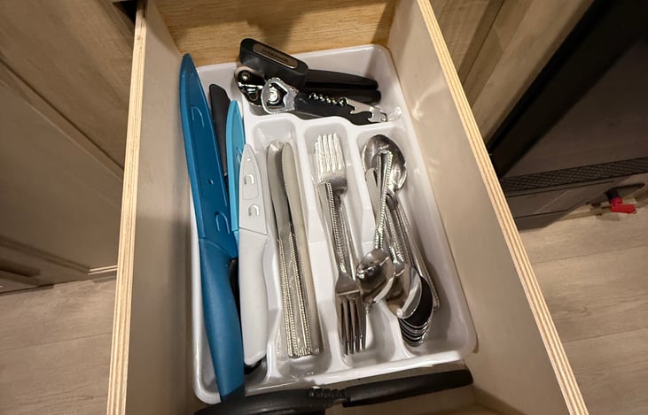 Utensils, scissors, bottle opener, knives, and can opener.