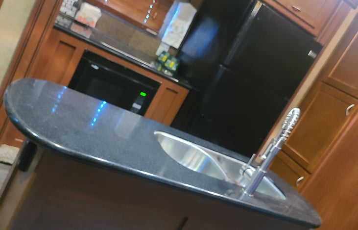 Full island/kitchen! 
Full size fridge and freezer. Gas stove and conventional oven/microwave