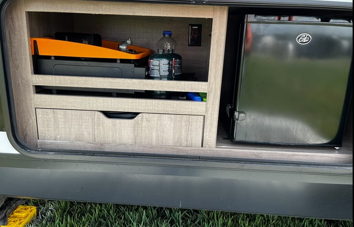 Outdoor Kitchen with mini fridge and gas stove. Pictured Blackstone Grill is optional add-on.