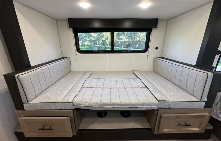 Dinette bed storage drawers and sleeping conversion detail.