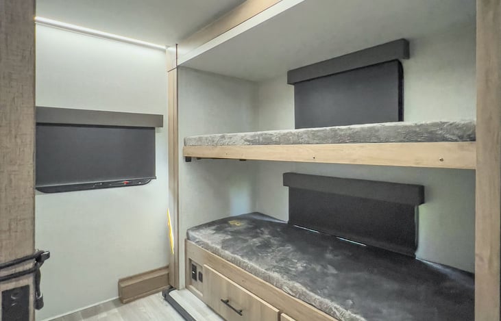 Open bunks 30 x 70 each. Top bunk folds up. Storage drawers underneath and cubbies located on the opposite wall.