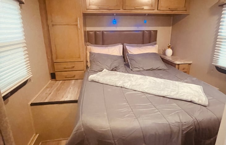 Large bedroom with wardrobe cabinets and window shades