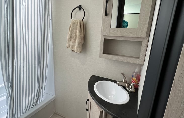 Storage for your toiletries. Hand soap and toilet paper are provided.