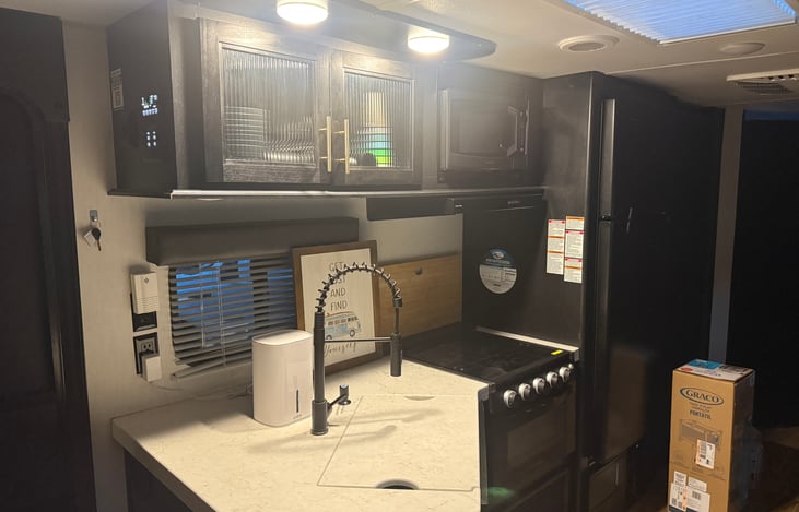 Kitchen, stove, fridge, pantry. Cabinets contain all plates/cups/utensils/cooking gadgets