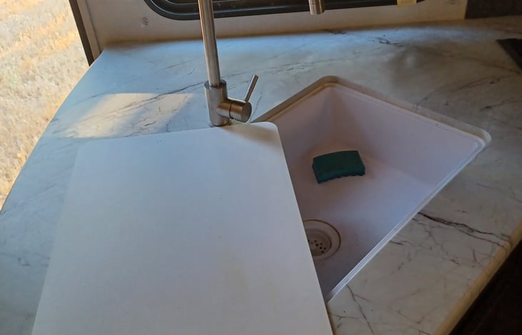 Sink has built in cutting board.