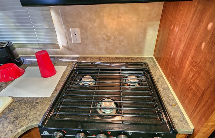 Three burner propane stove w/range.