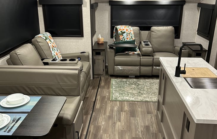 Spacious family room with four power recliners, USB ports, large windows & blackout shades. Loungers recline for sleeping. Inflatable mattress and bedding included.