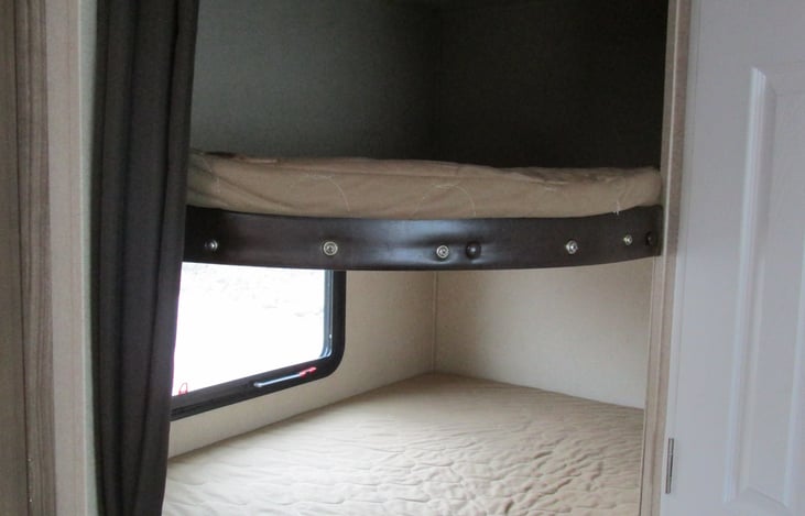 Close up - bunks with privacy curtain.