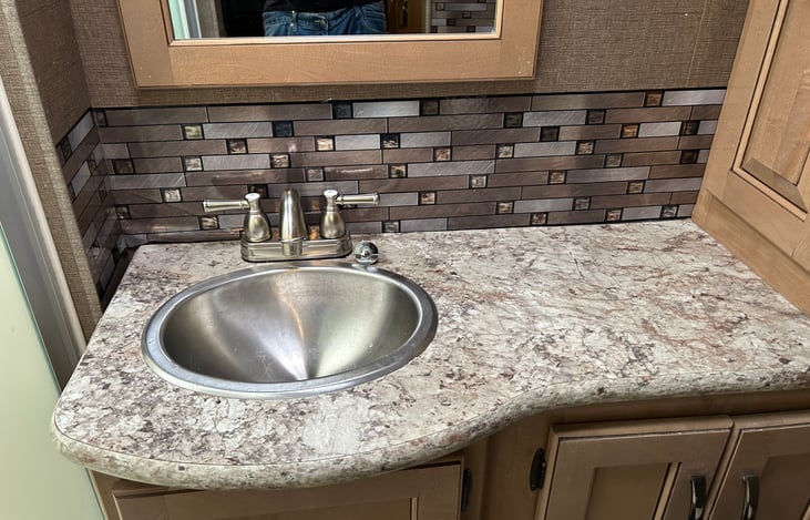 Bathroom includes towels, soaps, room deodorizer, medicine cabinet, TP