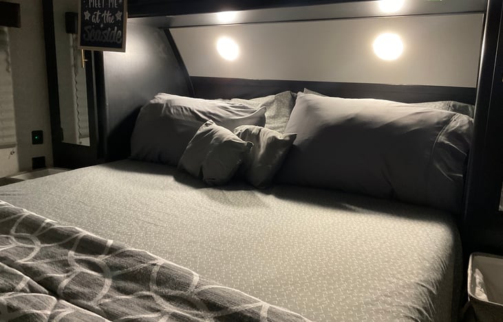 Master bedroom - Queen bed with overhead reading lights on equipped with a 10” gel-infused memory foam mattress made-up and ready for a good night’s rest.