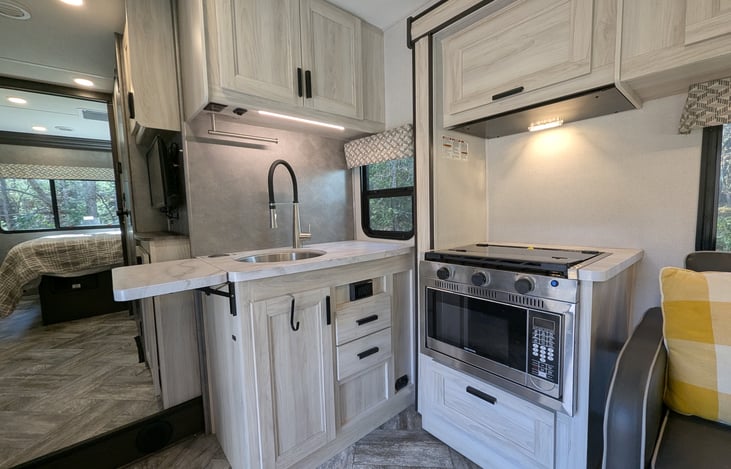 Spacious, bright & modern interior. Well-stocked kitchen with stove-top and convection microwave. Comfy couch and dinette both convert to beds. Large overhead bunk with swing-out TV for entertainment.