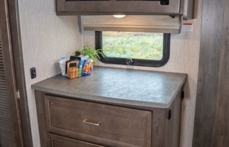 Dresser and entertainment center in the primary suite features deep oversized drawers offering ample storage.  Bed also has drawers under as well as overhead.  There is a wardrobe closet as well.