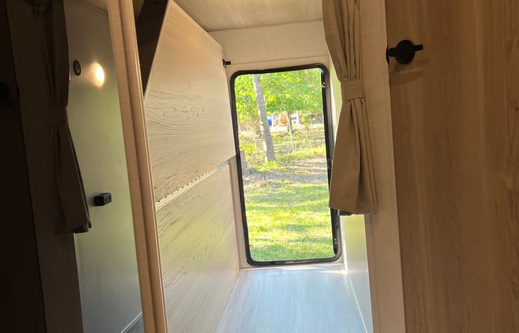 Bottom bunk folds up with large door for oversize storage items like kayaks and bikes.