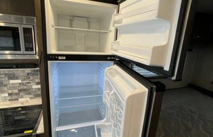 Nice size refrigerator for your snacks and groceries! It runs while you are driving!