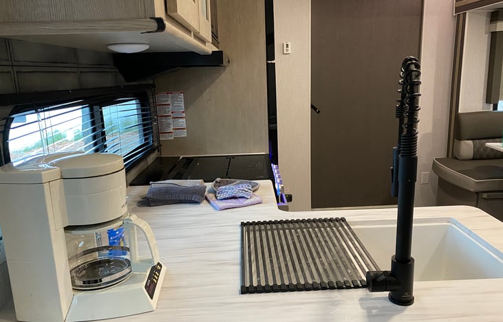 Kitchen sink and counter top.  There is also a cutting board that will fit over half of the sink.  (Coffie pot included)