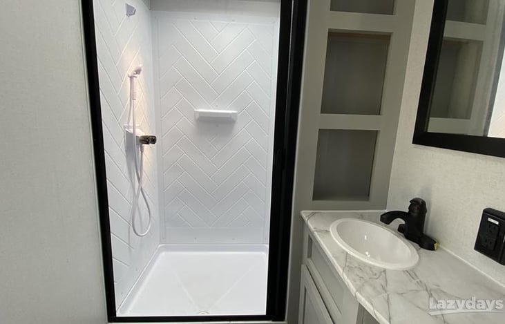 Bathroom - large shower, porcelain toilet, and sink/vanity, complete with towels, hand towels, and washcloths.