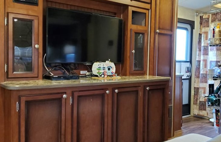 TV with lots of storage areas above, below and on both sides.