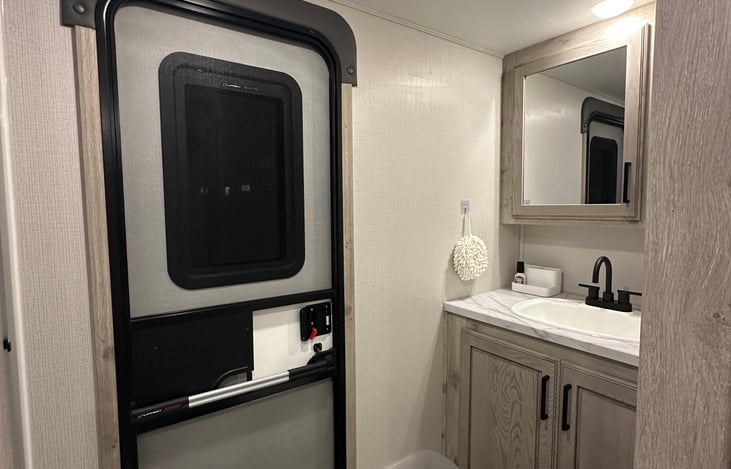 Second bathroom; access from rear of camper prevents need from walking through camper.
